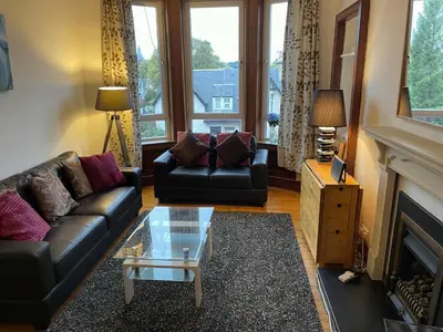 a living room with a couch and a fireplace at Scotstoun Appartments in Glasgow