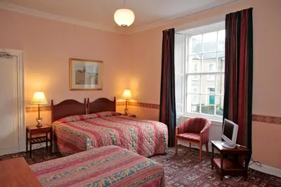 a hotel room with two beds and a window at Averon Guest House in Edinburgh
