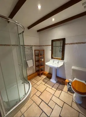 a bathroom with a glass shower and a sink at Broomhall Castle Hotel in Stirling