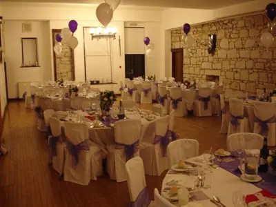 a room full of tables and chairs with purple balloons at Broomhall Castle Hotel in Stirling