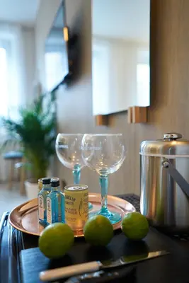 a tray with two wine glasses and tongs on a table at Rabble in Edinburgh
