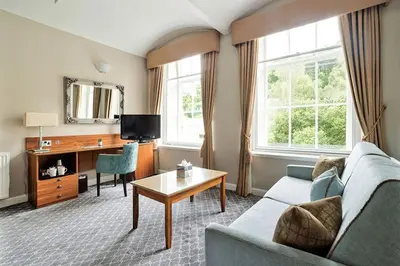 a living room with a couch and a table at New Lanark Mill Hotel in Lanark