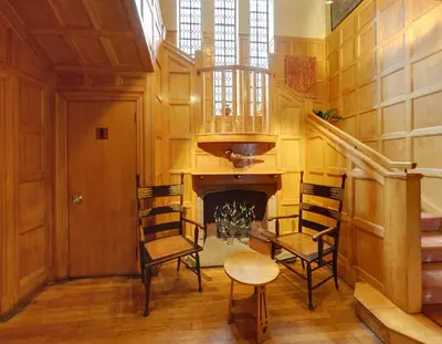 a room with two chairs and a fireplace at Trigony Hotel and Garden Spa in Closeburn