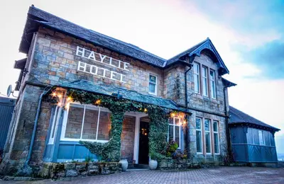 a brick building with a sign on the front of it at Haylie Hotel in Largs