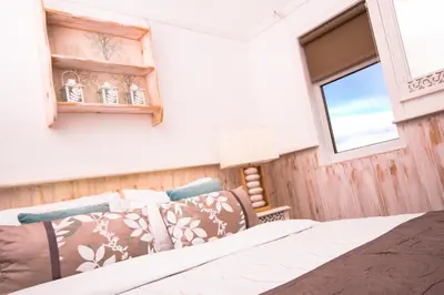 a bedroom with a bed and a window at Haylie Hotel in Largs