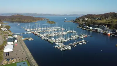 an aerial view of a marina with boats in the water at The waterfront in Tarbert