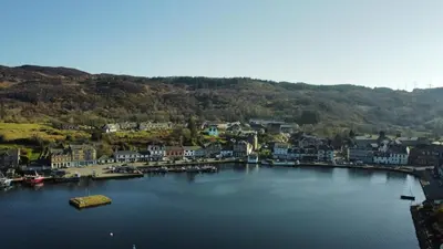 an aerial view of a town on a body of water at The waterfront in Tarbert