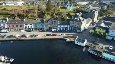 an aerial view of a town with a harbor at The waterfront in Tarbert