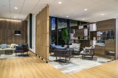 a lobby with chairs and a couch at Courtyard by Marriott Edinburgh West in Edinburgh