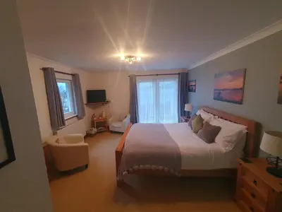 a bedroom with a large bed and a window at Appin Bay View in Appin