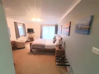 a bedroom with a bed and a window at Appin Bay View in Appin
