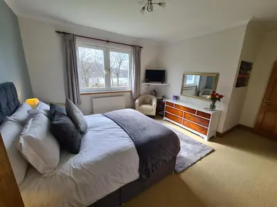 a bedroom with a bed with a mirror and a dresser at Appin Bay View in Appin