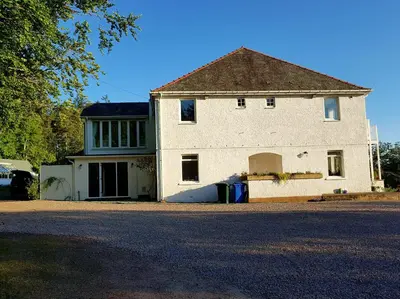 a large white building with a large garage at Appin Bay View in Appin