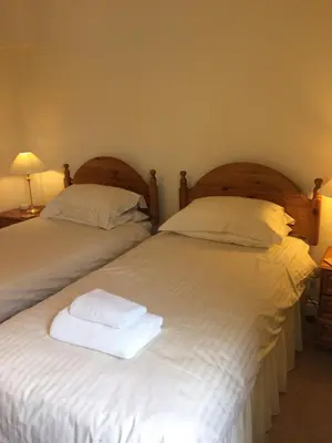 two beds sitting next to each other in a room at 1/5 Lismore House in Oban
