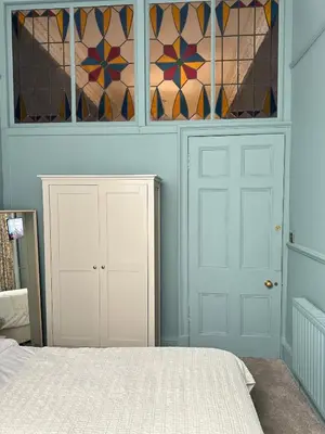 a bedroom with a bed and stained glass windows at Georgian House in Edinburgh