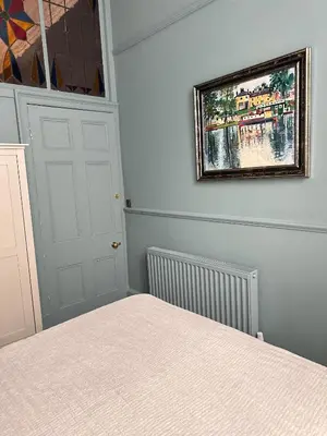 a bedroom with a bed and a picture on the wall at Georgian House in Edinburgh