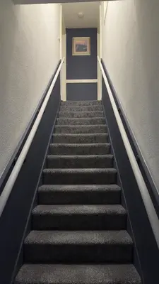 a stairway in a building with a blue door at Georgian House in Edinburgh
