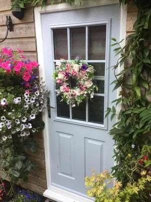 a door with a flower wreath on it at Angel Cottage in Drymen