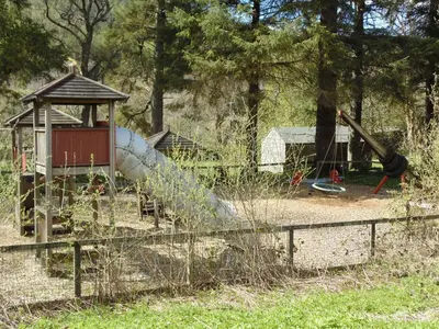 a playground with a slide and a slideintend at Craigdarroch Cottage in Strathyre