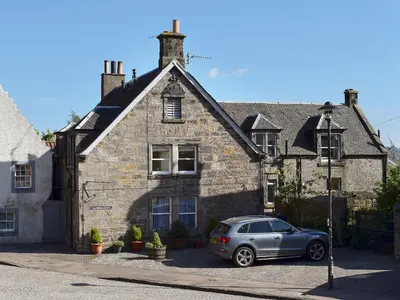 a car parked in front of a stone house at Sandhaven in Culross