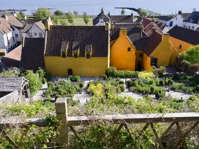 a village with yellow houses and a garden at Sandhaven in Culross