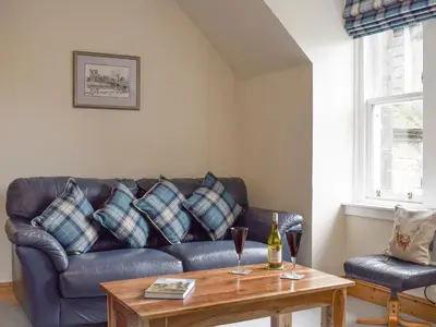 a living room with a couch and a table at Sandhaven in Culross