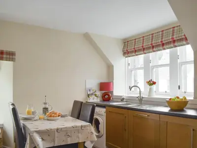 a kitchen with a sink and a washing machine at Sandhaven in Culross