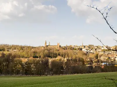 a town on a hill with a green field at Nether Cottage in Saline