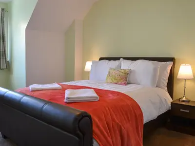 a bedroom with a bed with two towels on it at Harbour View in Oban