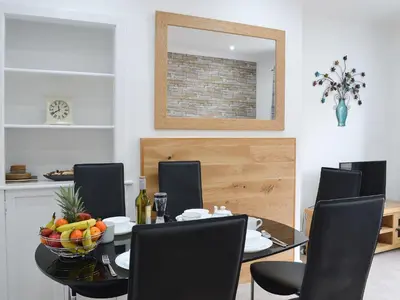 a dining room with a table with a bowl of fruit on it at Rocky Mountain View in Ballachulish