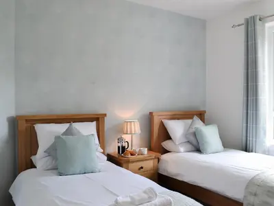 two beds sitting next to each other in a bedroom at Rocky Mountain View in Ballachulish