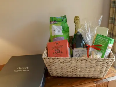 a basket of groceries sitting on top of a table at Bonnie's Bothy in Port of Menteith
