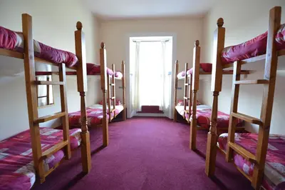 a room with four bunk beds and a window at Oban Backpackers in Oban
