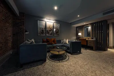 a living room with two couches and a table at Dakota Eurocentral in Motherwell
