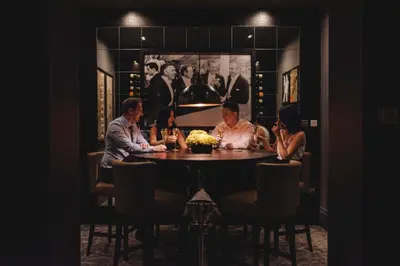 a group of people sitting around a table in a restaurant at Dakota Eurocentral in Motherwell