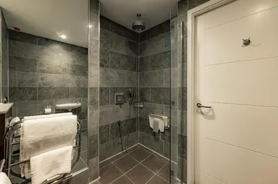a bathroom with a shower with a glass door at Dakota Eurocentral in Motherwell