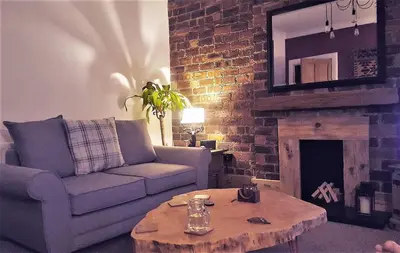 a living room with a couch and a coffee table at Snug - Krayr Apartment in Helensburgh