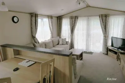 a living room with a couch and a table at West Loch Shores in Tarbert
