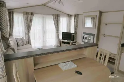 a living room with a couch and a television at West Loch Shores in Tarbert