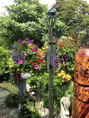a garden with a lamp post and flowers at The Moorings in Tarbert