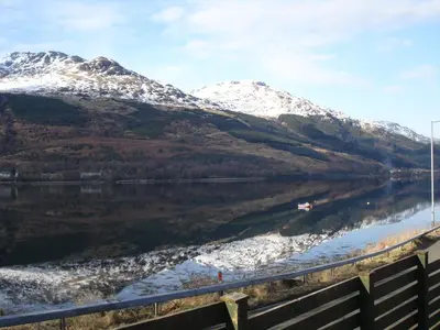 a view of a lake with snow covered mountains at 16 Admiralty in Arrochar