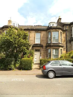 a gray car parked in front of a house at Menzies Guest House in Edinburgh