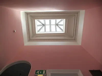 a window in a room with a pink wall at Menzies Guest House in Edinburgh
