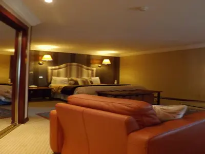 a hotel room with a bed and a couch at Castlecary House Hotel in Cumbernauld