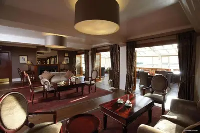 a living room with a couch and a table at Buchanan Arms Hotel & Leisure, Sure Hotel Collection in Drymen