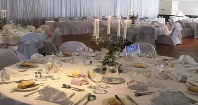 a table with white tables and chairs in a room at Buchanan Arms Hotel & Leisure, Sure Hotel Collection in Drymen