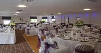 a room filled with tables and chairs with white table linen at Buchanan Arms Hotel & Leisure, Sure Hotel Collection in Drymen