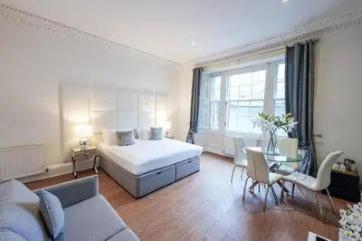 a bedroom with a bed and a living room at Hanover 71 Suites in Edinburgh