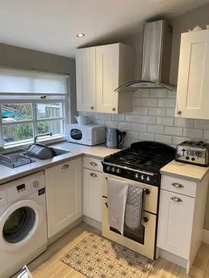 a kitchen with a stove and a microwave at Sea Hollies in Aberdour