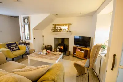 a living room with a couch and a table at Sea Hollies in Aberdour